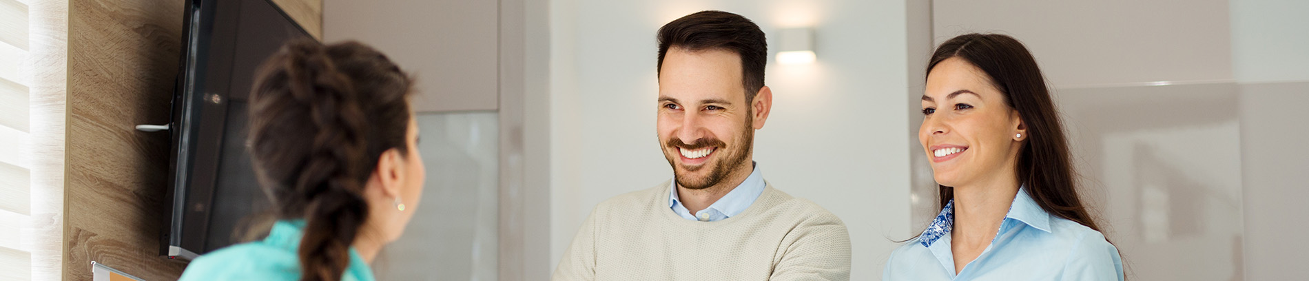 The image shows a modern dental clinic interior with various pieces of equipment, including a dental chair and an X-ray machine.